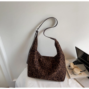 Detail of leopard print hobo bag with adjustable brown strap and zipper closure