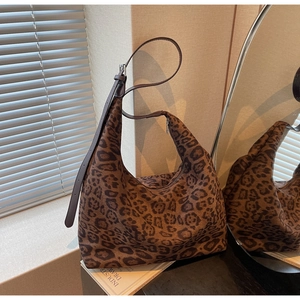 Macro shot of large leopard print hobo bag showing thick canvas texture and pattern detail