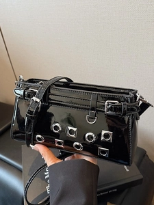 Punk style black patent leather crossbody bag with silver eyelets and studs detailing