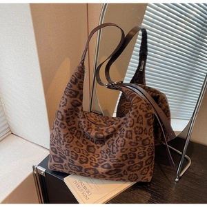 Detailed view of large leopard print tote bag with soft texture and leather strap