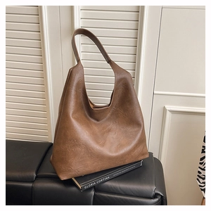 Macro view of brown large capacity Hobo bag featuring a vintage leather texture finish