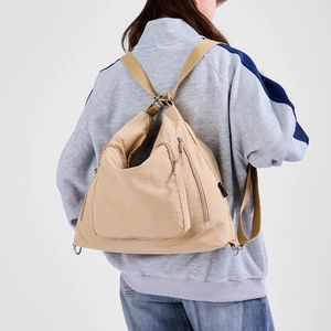 Detail of the high-density apricot nylon fabric and adjustable woven straps on the tote