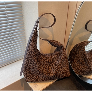 Detail of large leopard print hobo bag with adjustable leather strap and silver hardware