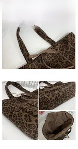 Detail view of suede leopard print tote bag with bow accent and spacious inner lining