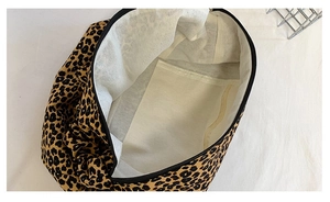 Detail view of the leopard print canvas bag interior showing inner pocket and zipper
