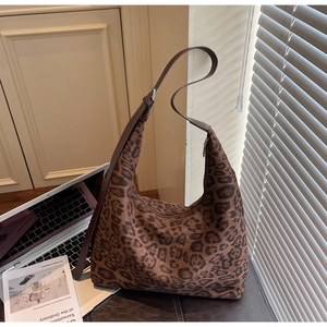 Detail of leopard print hobo bag in suede texture with adjustable leather strap