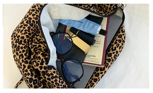 Interior of leopard print tote bag showing capacity for tablet, makeup, and daily essentials