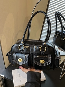 Retro black faux leather Boston bag with white stitching and front pockets