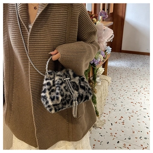 Close-up of leopard print faux fur bucket bag with silver chain and tassel detail