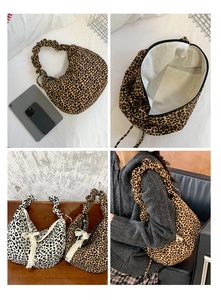 Detail of leopard print tote bag with ruched shoulder strap and secure zipper closure