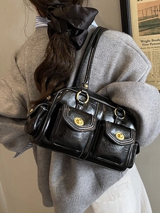Vintage black pillow bag with dual front pockets and metallic gold hardware for women
