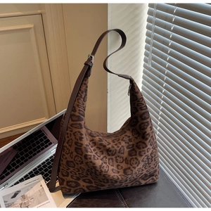 Detail of hobo leopard print tote with adjustable leather strap and silver hardware