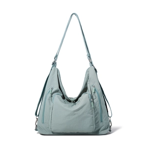 Detail showing the light teal nylon tote with multi-pocket design and adjustable straps