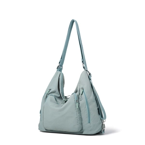 Detail view of mint green waterproof nylon bag with functional zipper pockets