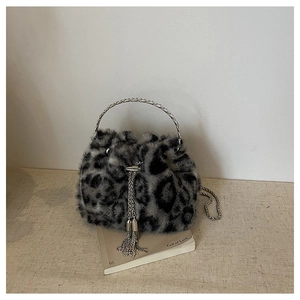 Detail of leopard print faux fur bucket bag with metal chain strap and tassel