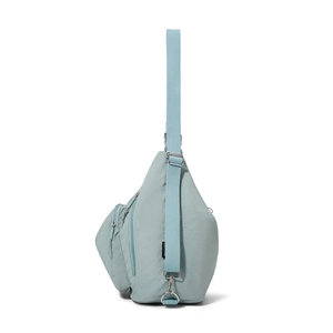 Detail view of the light green nylon crossbody bag showing side zipper and adjustable strap