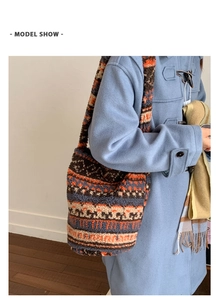 Close-up of geometric pattern plush tote bag worn with a light blue toggle coat