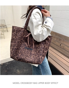 Detail of leopard print suede tote bag with front pocket and bow tie accessory