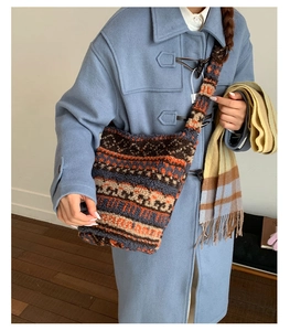 Detail of vintage geometric fleece crossbody bag styled with a blue coat and plaid scarf