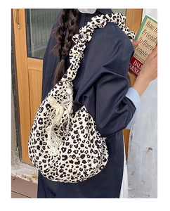 Close-up of leopard print canvas bag with ruffled strap and pearl fringe charms