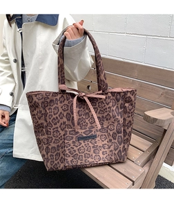 Detail of leopard print suede tote bag with drawstring bow and woven brand label