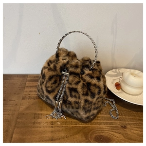 Detail of leopard print faux fur bucket bag with silver metal handle and chain strap