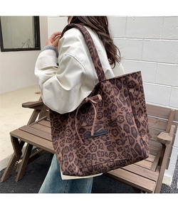 Detail of leopard print suede tote bag with outer pocket and drawstring side