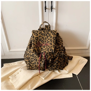 Detail of leopard print canvas backpack with red drawstring and brand embroidery
