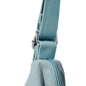 Close-up of adjustable woven shoulder strap and metal hardware on blue tote bag