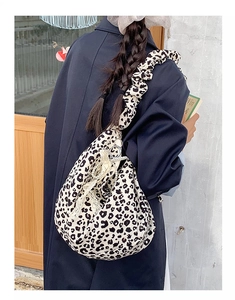 Detail of leopard print tote bag with scrunched shoulder strap and pearl chain charm