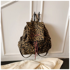 Detail of red Berlichien embroidery on leopard print canvas backpack with drawstring cord