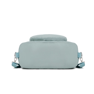 Detail of adjustable strap and silver metal buckle on mint green nylon shoulder bag