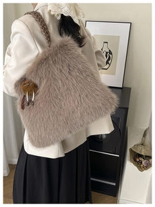 Macro detail of plush faux fur tote bag with brown woven handle and cute bear charm