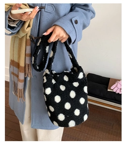 Close-up of black and white polka dot faux fur plush bucket bag with soft texture