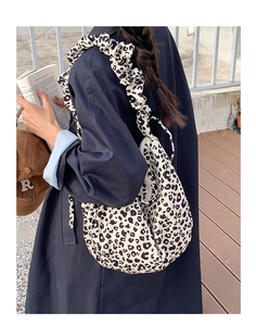 Detail of trendy leopard print tote bag with stylish scrunchie pleated shoulder strap
