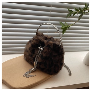 Close-up of leopard print faux fur bucket bag with silver metal ring handle and chain detail