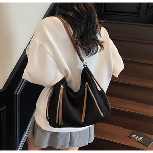 Black matte tote bag with dual zippers shown on model for daily commuting use