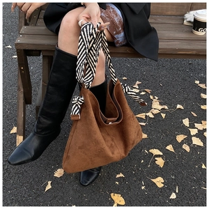 Brown frosted suede tote bag with black and white striped woven wide shoulder strap