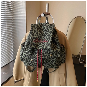 Close-up of leopard print canvas backpack featuring red Bailuchen embroidery and drawstrings