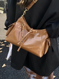 Vintage caramel oil-wax leather tote bag with side pockets and brass hardware for commuting