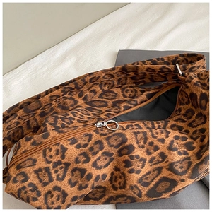 Close-up of leopard print tote bag with silver metal ring zipper and fine fabric texture