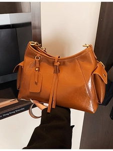 Caramel vintage oil wax leather tote bag with side pockets and tassel accents
