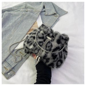 Detail of faux fur bucket bag with leopard print, silver chain, and drawstring closure