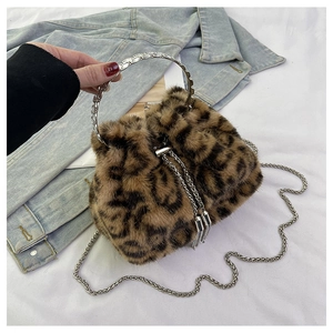 Detail of leopard print faux fur bucket bag with silver metal handle and chain strap