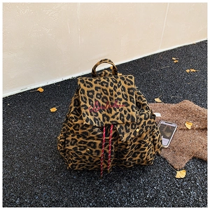 Detail of leopard print canvas backpack with red embroidery and drawstring closure