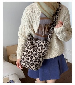 Detail of plush leopard print tote bag showing soft faux fur texture and wide shoulder strap