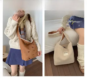 Detail showing brown embroidery puppy tote and white fleece seeyou shoulder bag