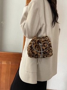 Faux fur leopard print bucket bag with metal ring handles and silver chain strap
