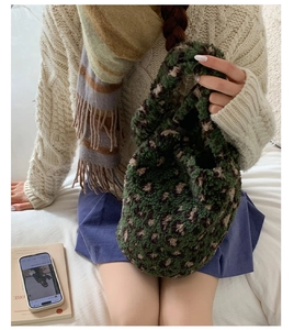 Detailed texture of green and brown leopard print sherpa bucket bag with plush material
