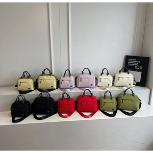 Detailed arrangement of multi-color nylon crossbody bags with dual zippers and woven handles